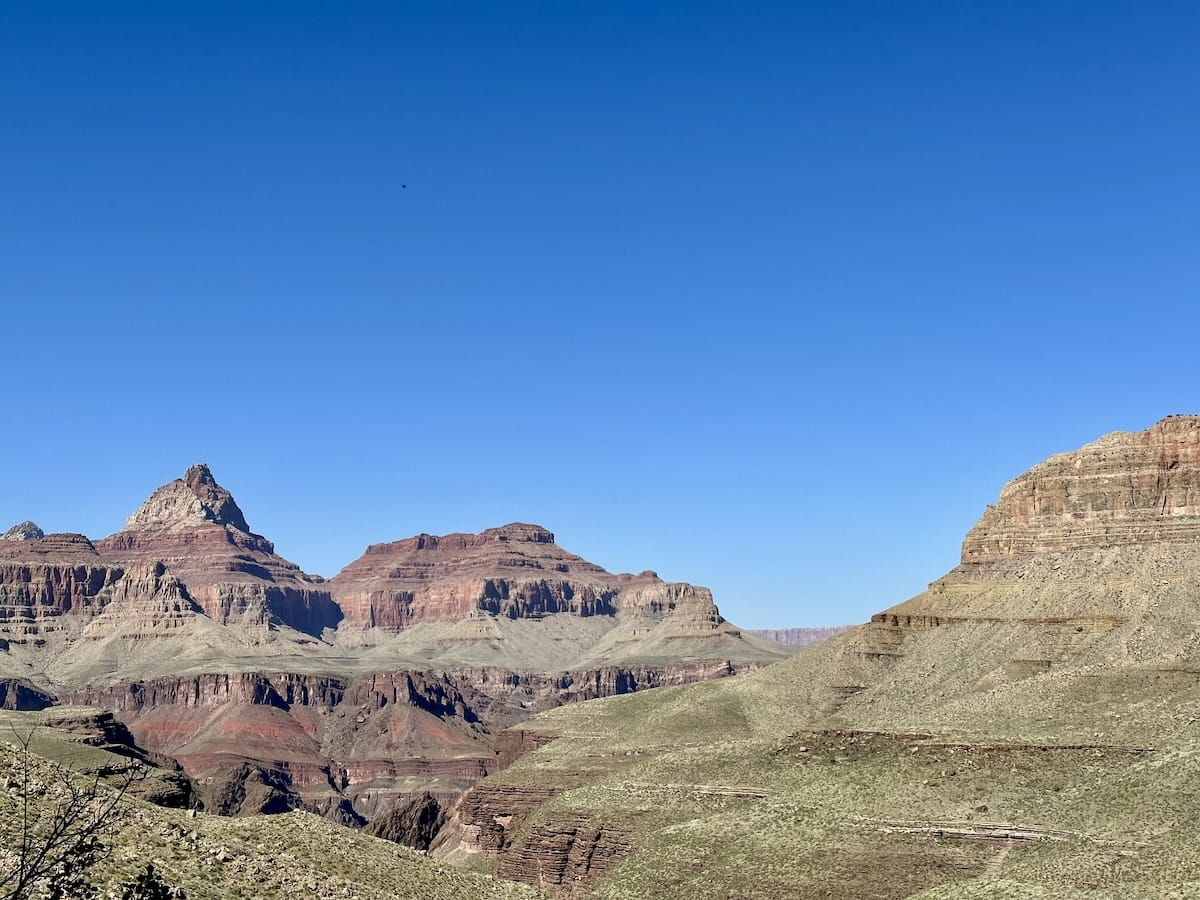 canyon-panorama-grand-canyon-national-park Scenic view of the Grand Canyon with layered rock formations and a clear blue sky.