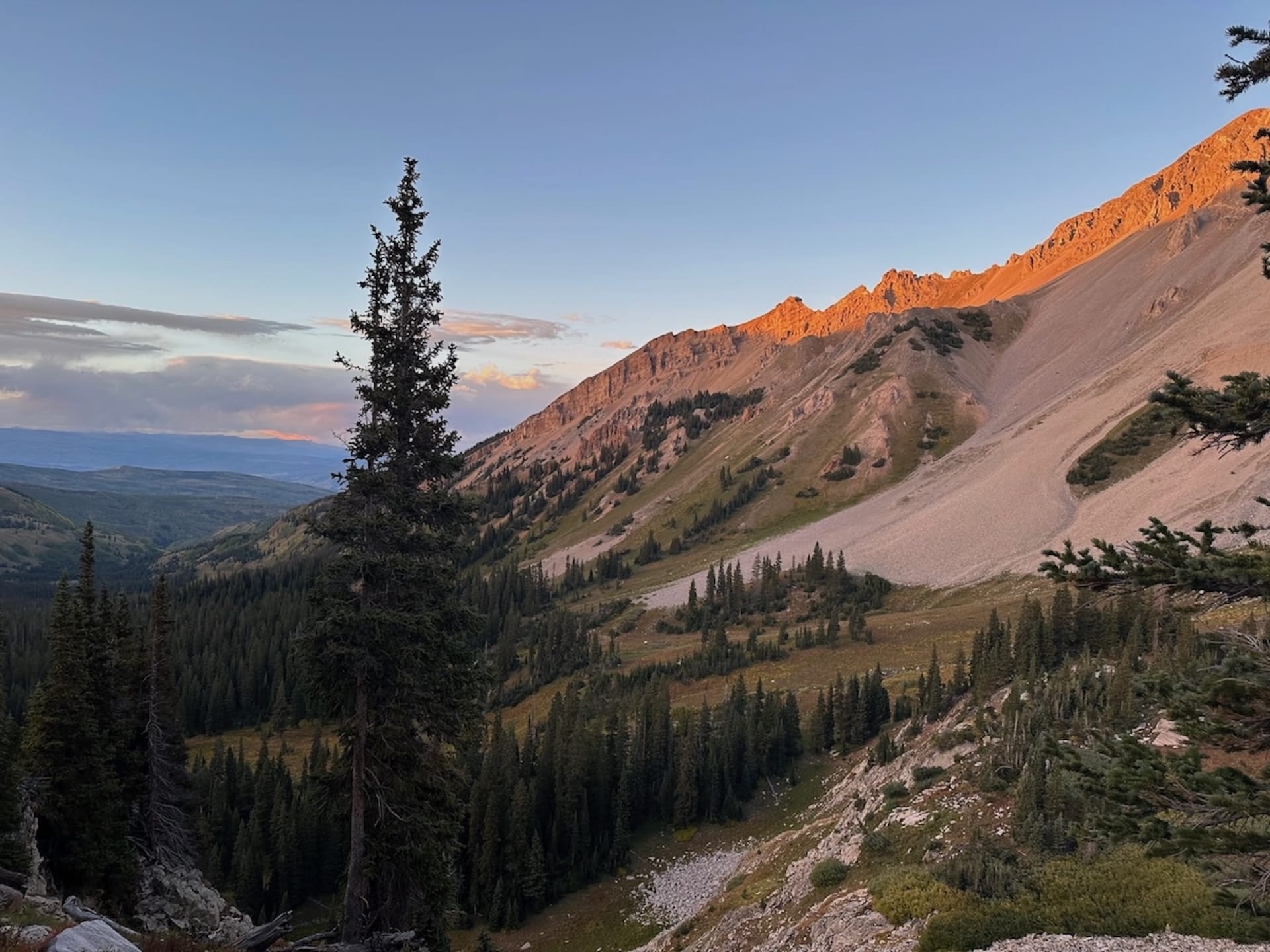 Scenic evening landscape on the Capitol Peak Trail with mountains and trees.