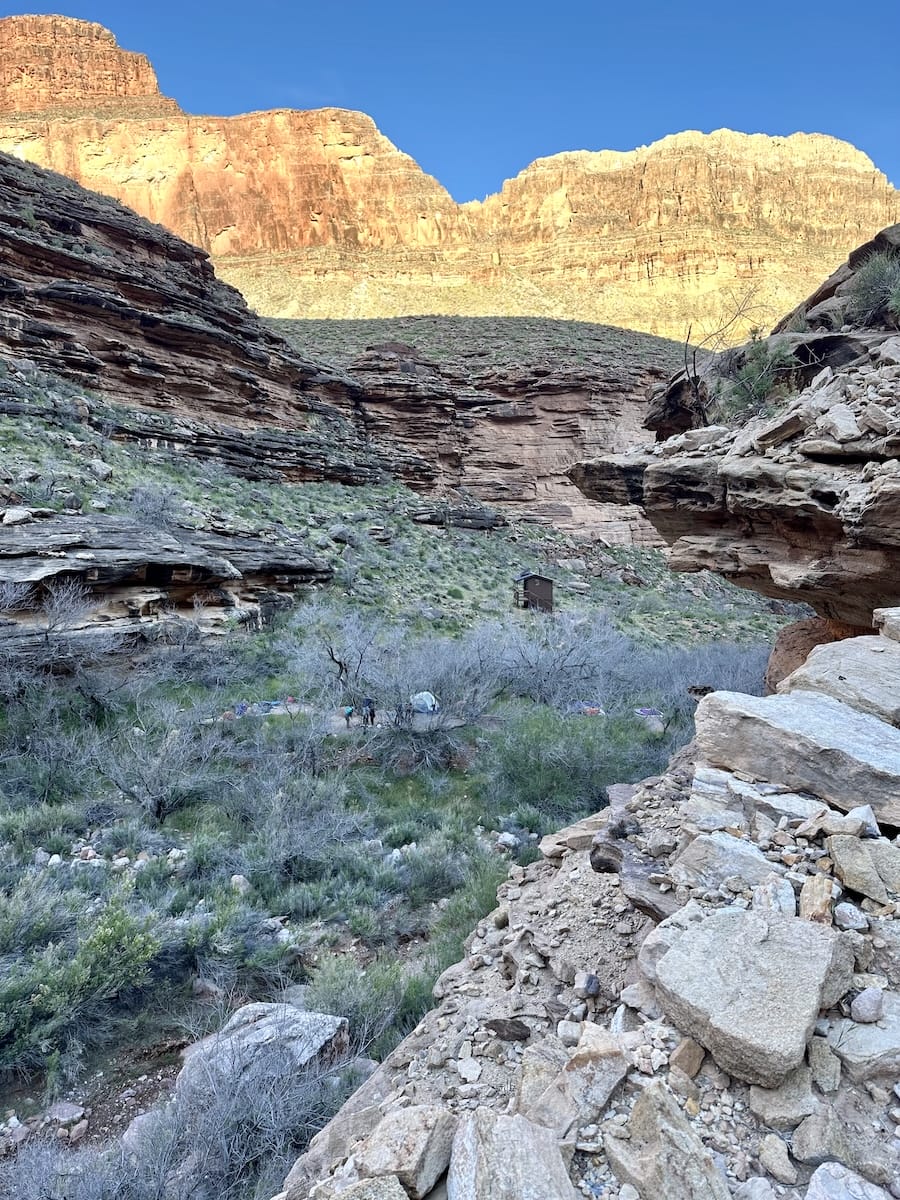 monument-campsite-grand-canyon-view Monument Campsite in Grand Canyon with privy, tents, and canyon views at sunrise.
