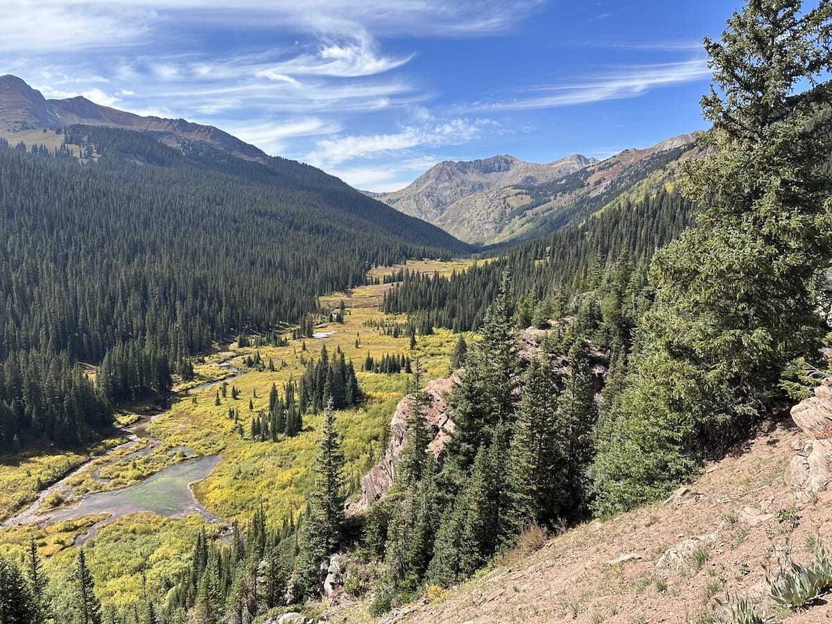 Mountain valley in the North Fork Zone of the Snowmass Wildersness with evergreen forest and winding river
