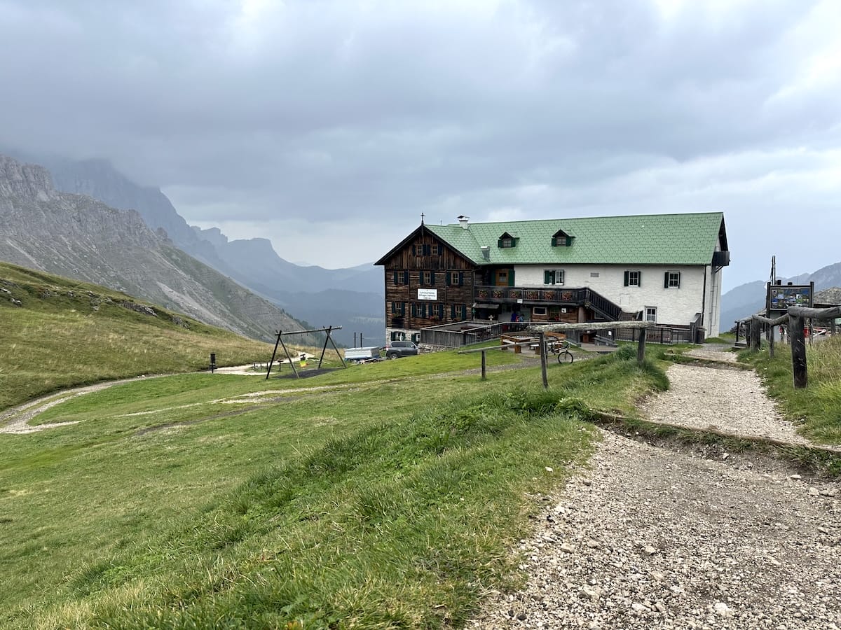 Rifugio Genova, a mountain hut along the Alta Via 2 trail, with mountain views.