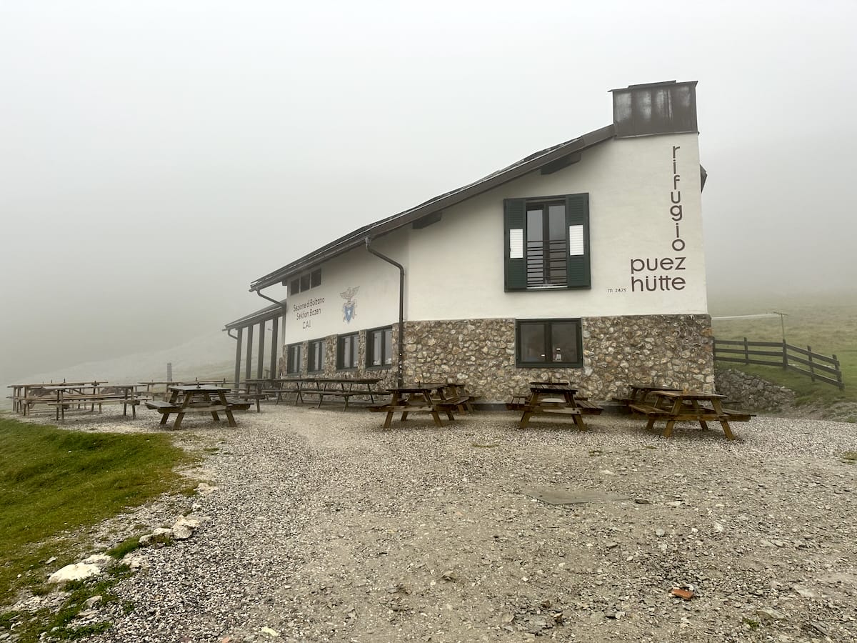 Rifugio Puez, a mountain hut along the Alta Via 2 trail, in foggy conditions.
