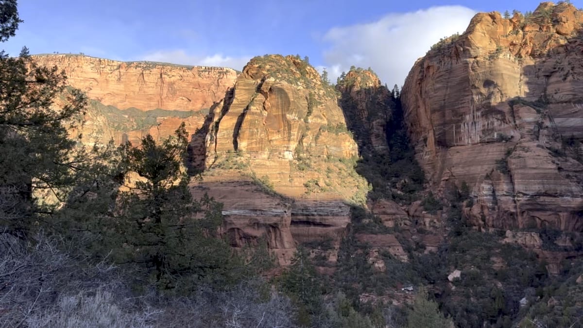 Red rock canyon walls in Zion National Park illuminated by sunlight.