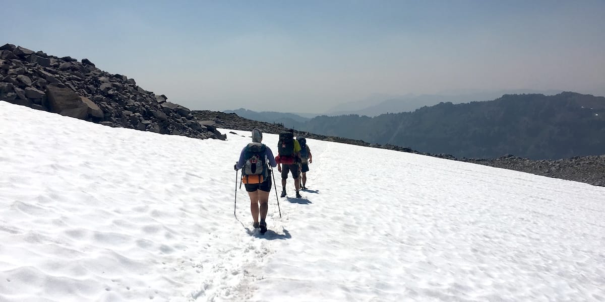 PCT thru hikers crossing a large snow field in Washington.