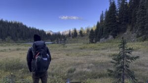 osprey-exos-48-geneva-lake Hiker in the early morning with backpack on overlooking Geneva Lake.