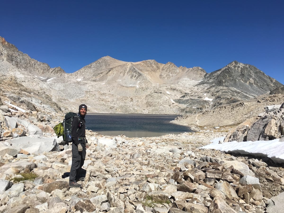 PCT hiker in the Sierra Nevada wearing cold weather backpacking gear.