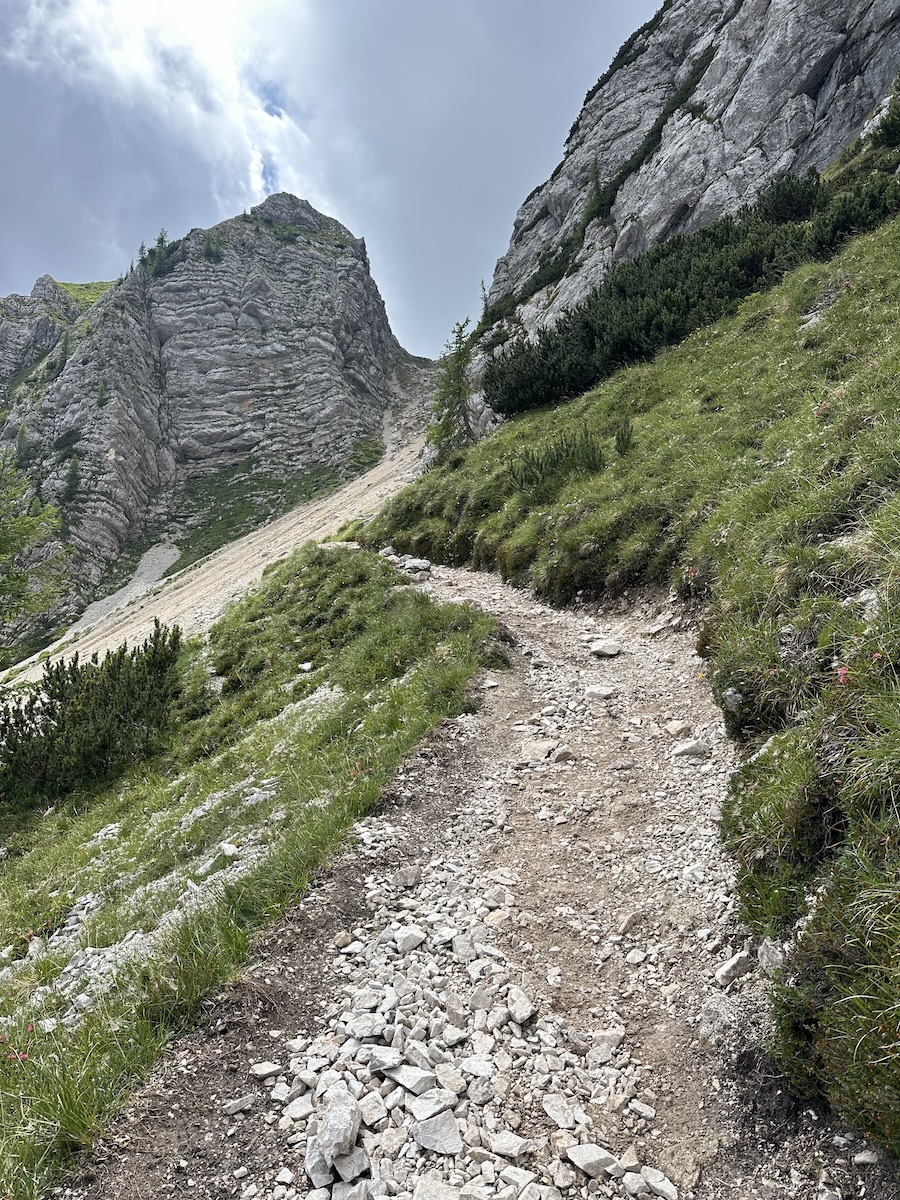 Rocky trail section above Vršič Pass climbing toward the scree saddle
