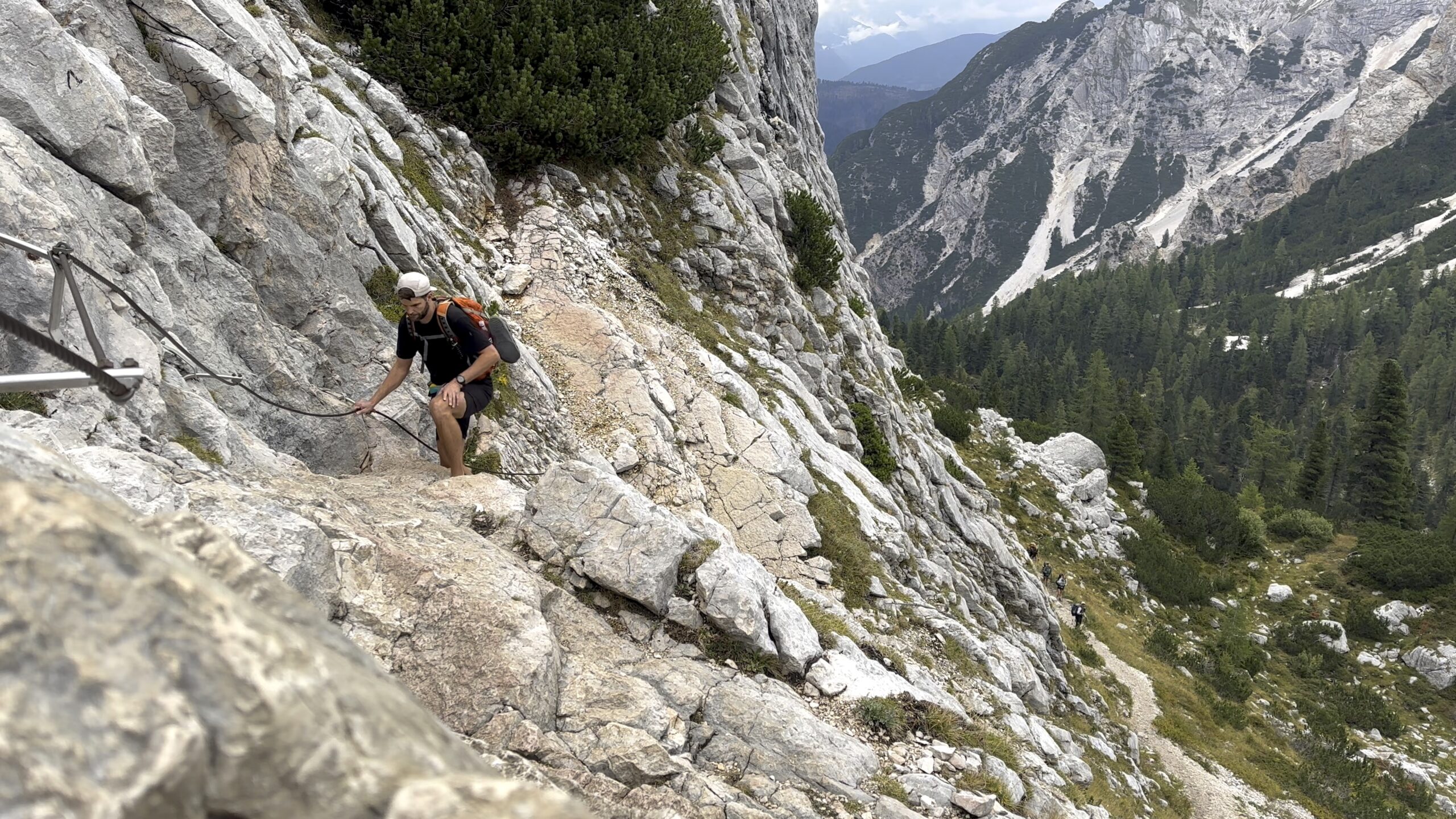 Hiker climbing aided section of the Alta Via 1