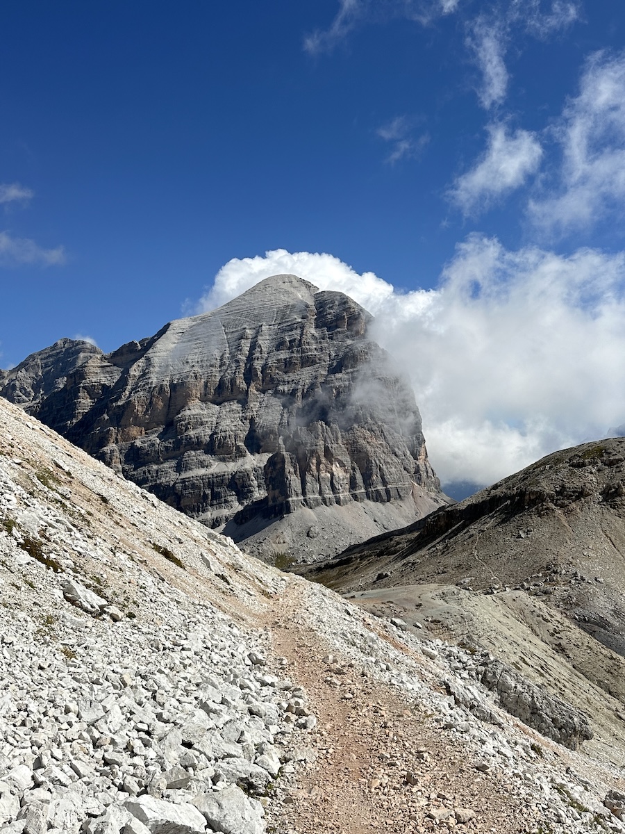 Rocky trail with clouds wrapping Tofana di Rozes