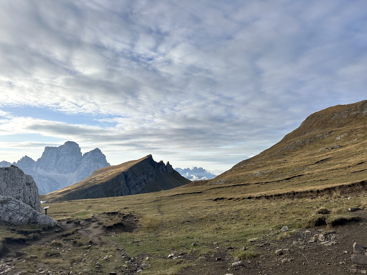 Wide grassy ridgeline with Dolomite peaks