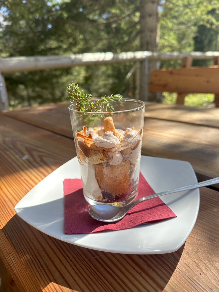 Glass of layered tiramisu-style dessert