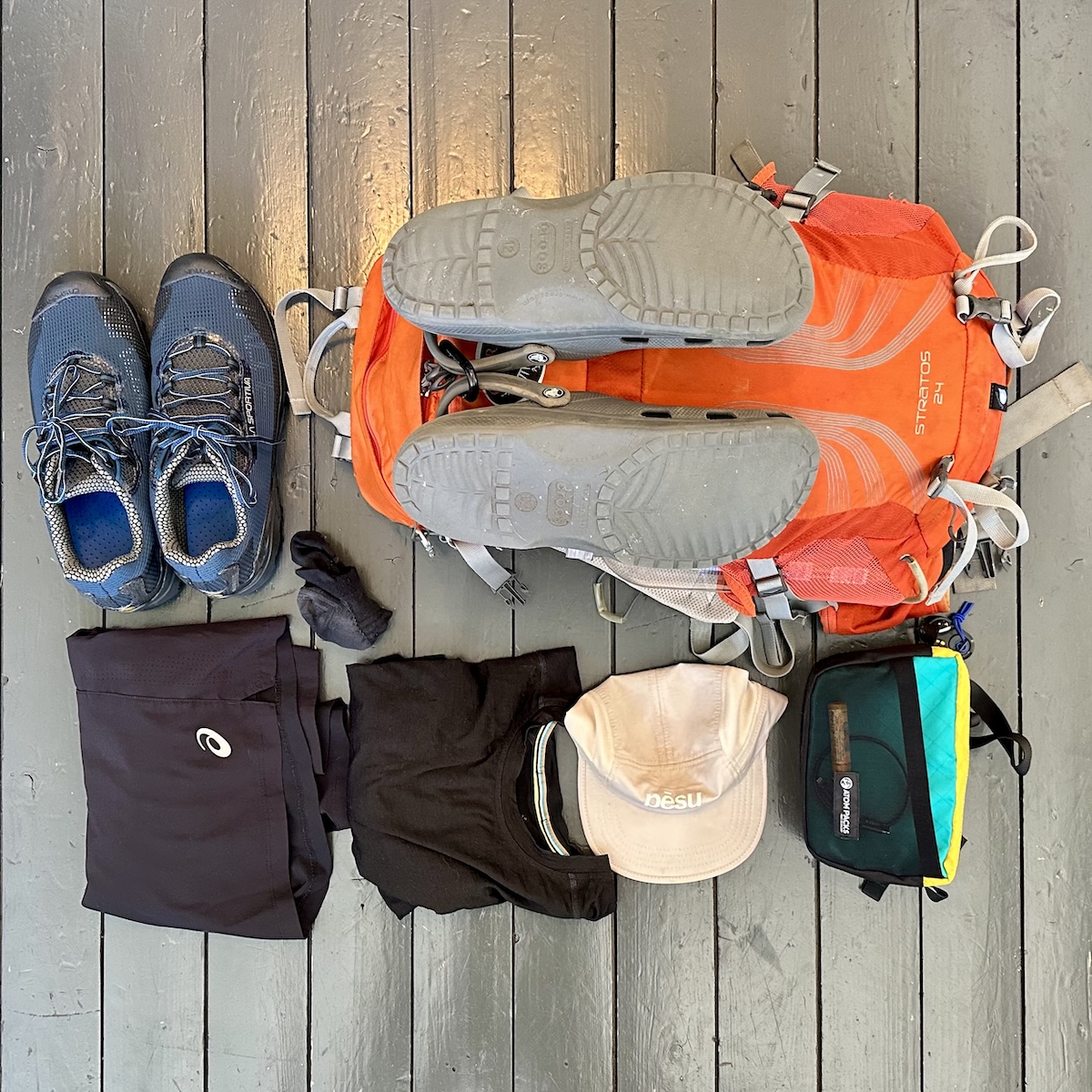 Essential hiking gear for Alta Via 1 trek in the Dolomites – Osprey Stratos 24L backpack, trail running shoes, lightweight clothing, hat, and packing cubes.