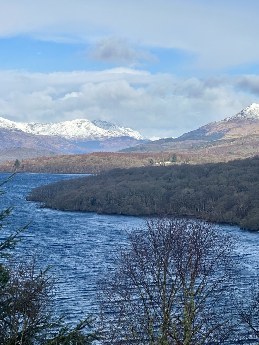 Elevated view north along Loch Lomond toward snow-covered peaks from the West Highland Way