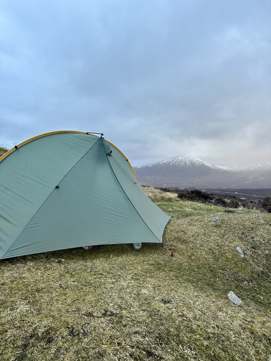 Tarptent Rainbow pitched on Rannoch Moor with a snow-covered peak behind on the West Highland Way.
