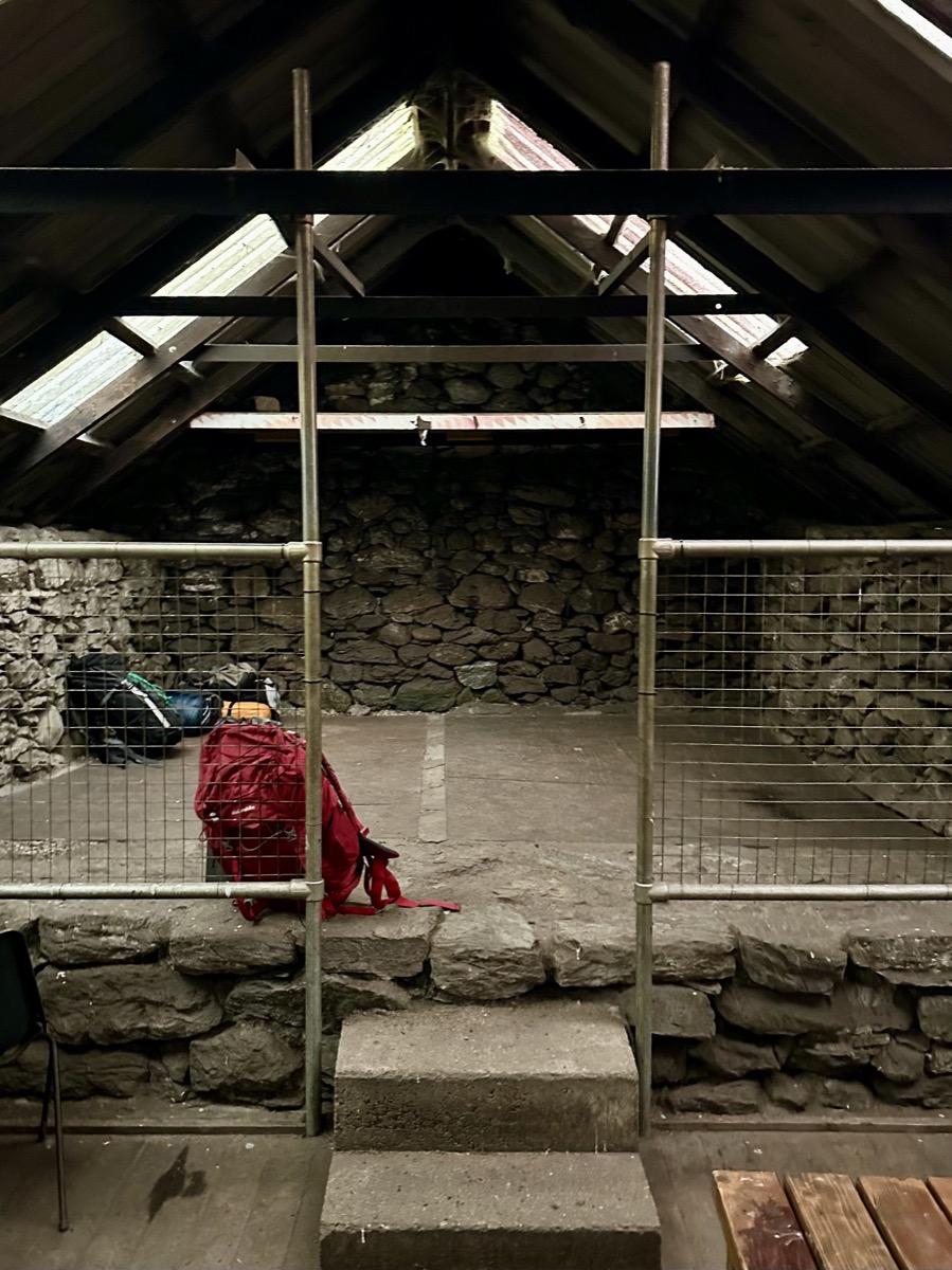 Entrance steps inside Rowchoish Bothy on the West Highland Way leading to the sleeping area