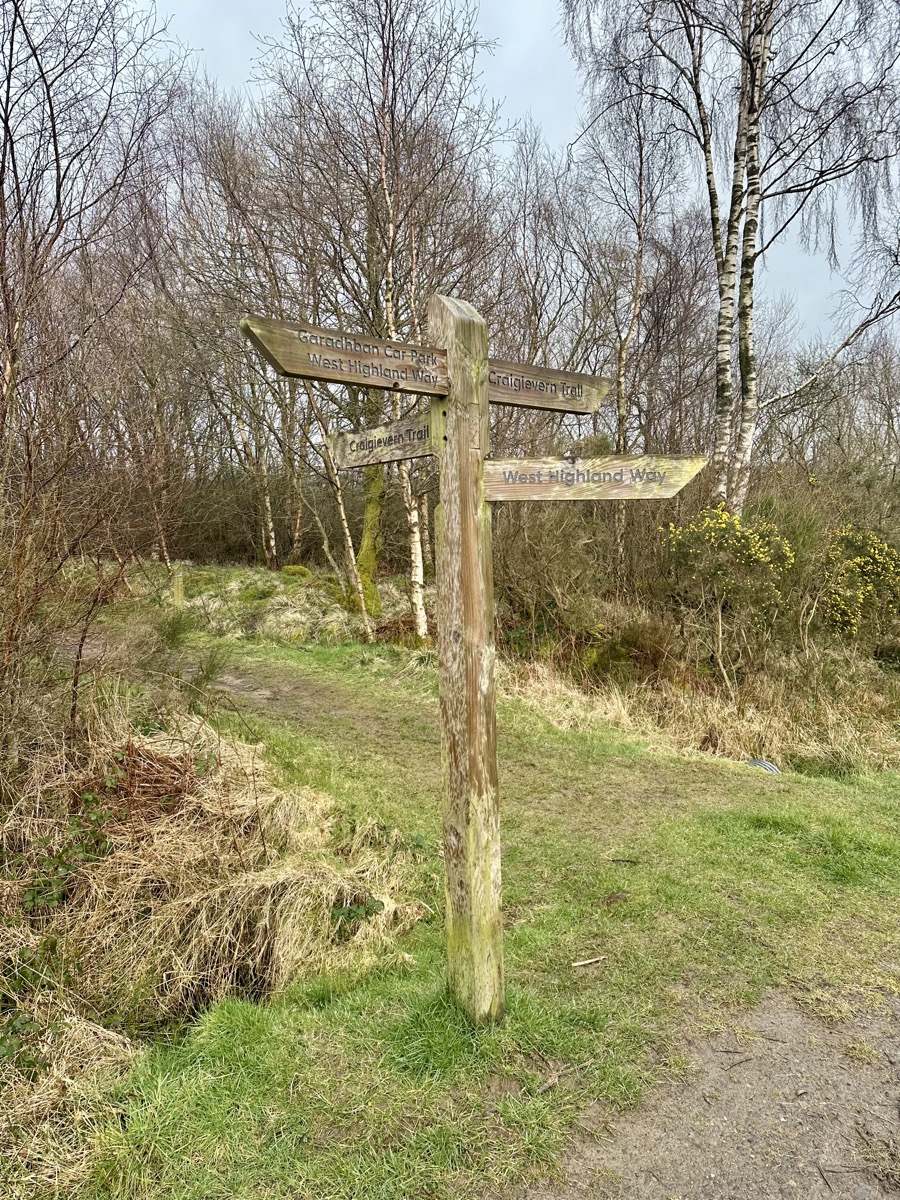 West Highland Way wooden signpost near Garadhban Forest north of Drymen