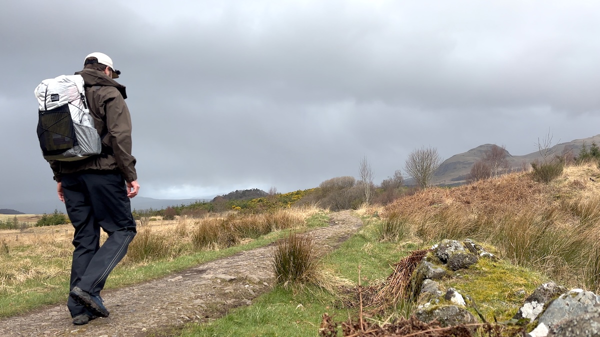 Tall hiker carrying the Hyberg Bandit Lite Aluula pack on the West Highland Way in overcast Scottish highland conditions
