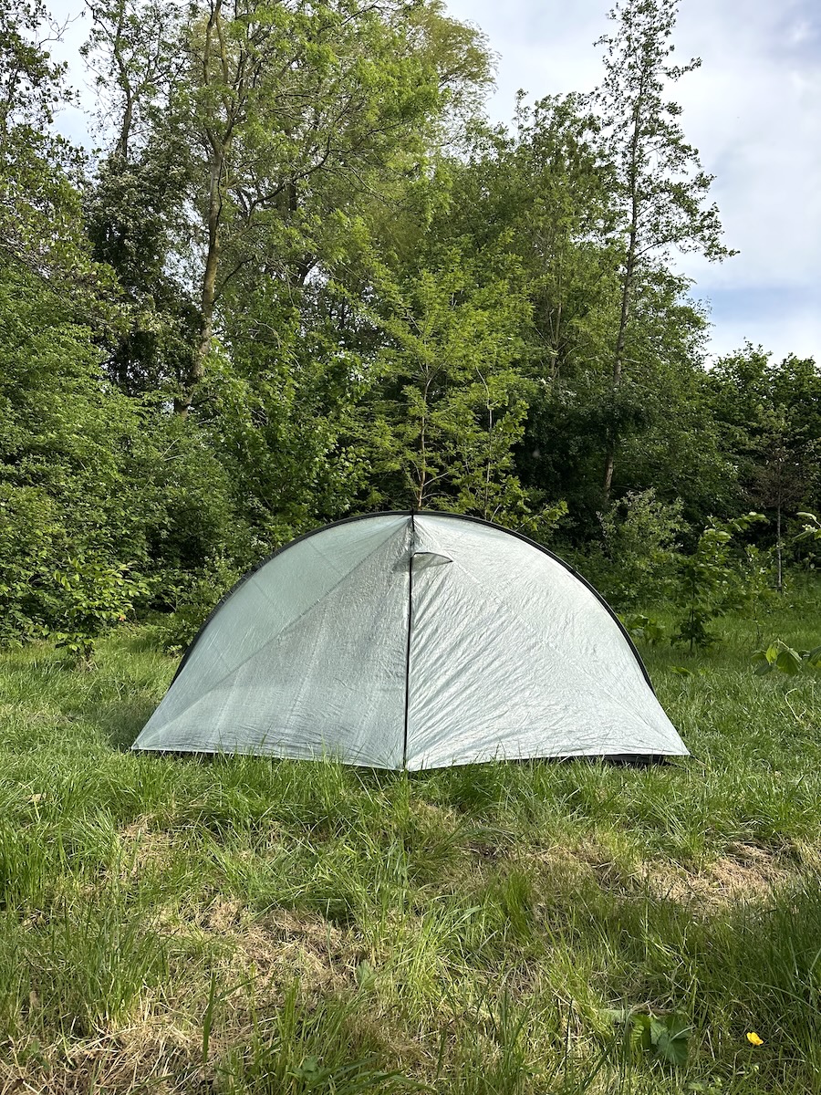 Tarptent Rainbow Li DCF ultralight tent pitched in a wooded clearing with door closed