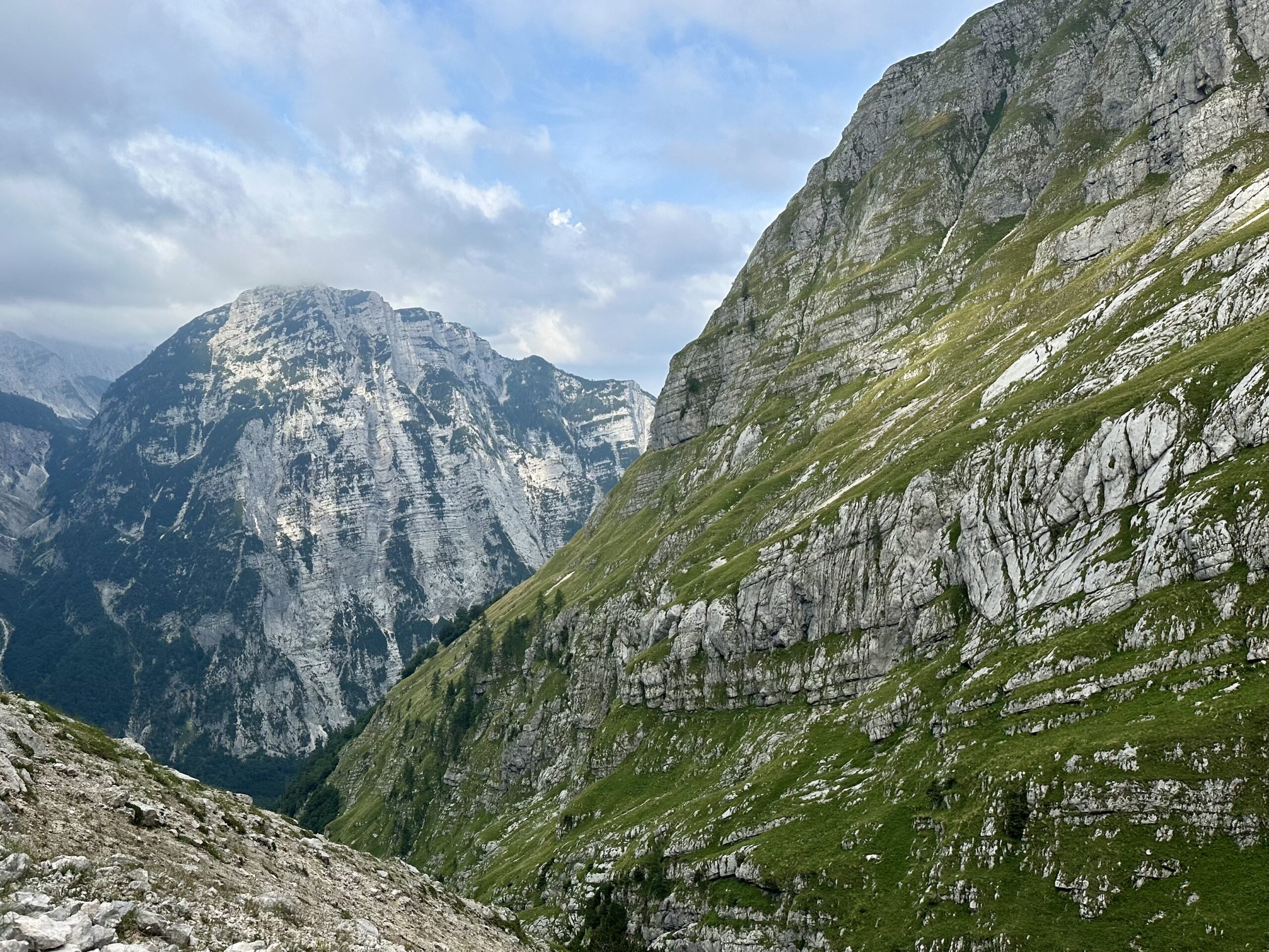 Grass-covered limestone slopes on the far side of the ravine below Luknja Pass, Soča Valley, Slovenia